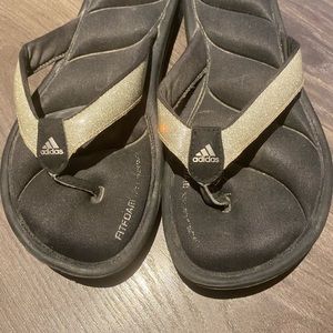 Black and glittery silver adidas flip flop